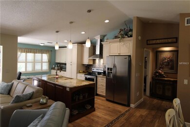 Beautiful Kitchen with large center island and stainless steel appliances....gorgeous granite counter tops and wood cabinets..