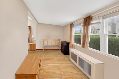 Bedroom with light wood finished floors and baseboards