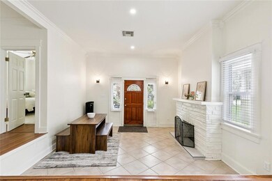 FOYER/ DINING ROOM W DECORATIVE FIREPLACE.