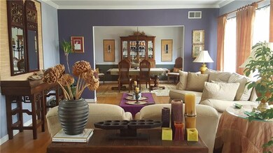 The spacious livingroom features crown molding and