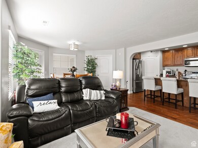 Living room featuring arched walkways and dark wood finished floors