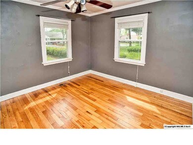 Master bedroom with beautiful hardwoods and crown moulding