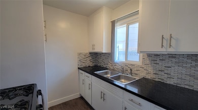 Kitchen featuring a sink, range with gas cooktop,
