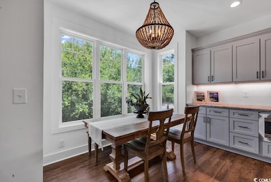 Dining area with dark wood-style floors, plenty of