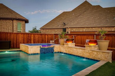 View of swimming pool featuring an in ground hot tub and pool water feature
