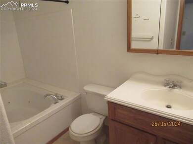 Bathroom with vanity, a bath, and toilet