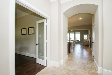 Upon entering the home there's a study with glass French doors on the left.   The tile starts at the front door and continues throughout the home.