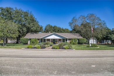 Single story home featuring a front lawn and a porch