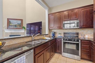 Kitchen featuring stainless steel appliances, dar