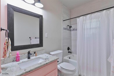 Full bathroom with shower / bath combo with shower