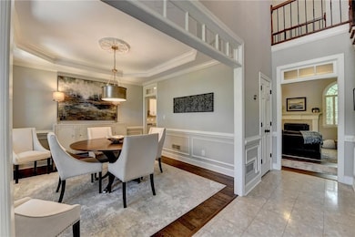 Dining room with a tray ceiling and hardwood floor