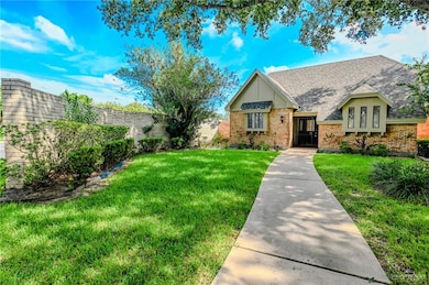 View of front of home featuring roof with shingles and brick siding