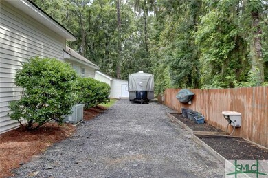 This gate with privacy fence leads to a long RV/bo