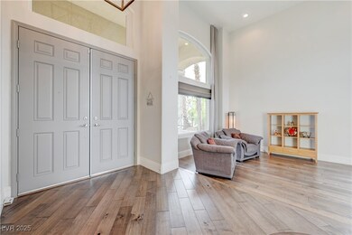 Foyer featuring wood finished floors, a towering c