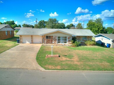 Single story home with a front yard and a garage