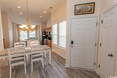 Dining room with baseboards, a chandelier, recesse