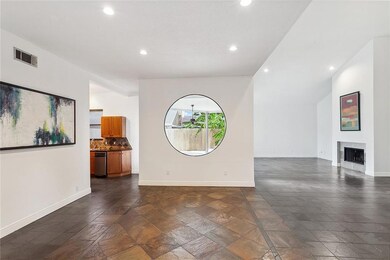 View from foyer into partial  view of kitchen, din