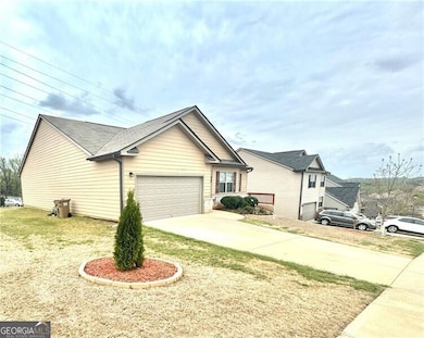 View of front of home with driveway and a garage