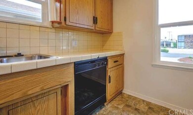 The bright kitchen is filled with light with direc