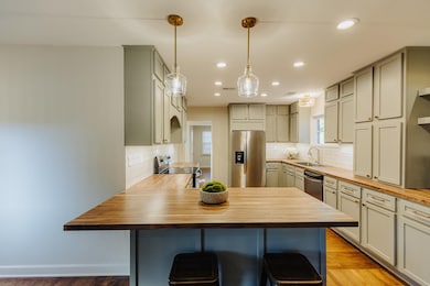 Kitchen featuring a breakfast bar, light hardwood 