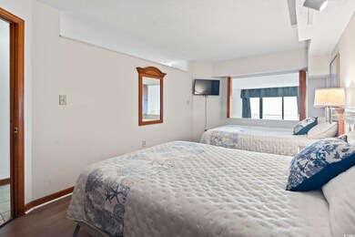 Bedroom with dark wood-type flooring and a texture