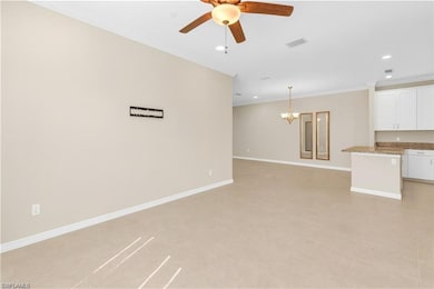 Unfurnished living room with crown molding, a chandelier, recessed lighting, light tile patterned flooring, and ceiling fan