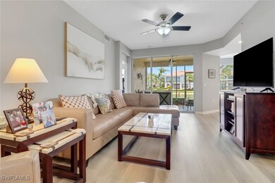 Living area featuring ceiling fan and light wood f