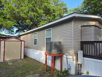 View of side of home featuring central AC unit