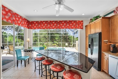 Kitchen featuring black appliances, crown molding,