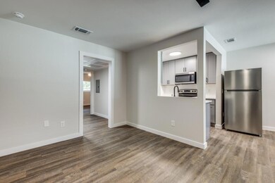 Kitchen featuring electric panel, wood-type floori