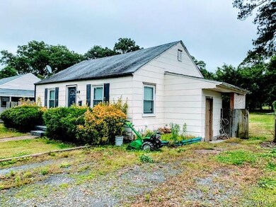 attached shed on side of house contains water heater, washer, and dryer (hookups located inside attached shed).