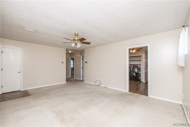 Bedroom with a ceiling fan and carpet