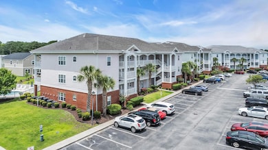View of property with uncovered parking and a residential view
