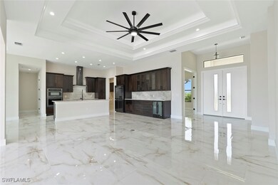 Unfurnished living room featuring a raised ceiling