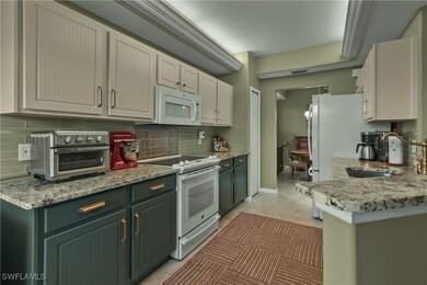 Kitchen with decorative backsplash, light stone co