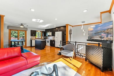 Open modern layout features updated kitchen, wood floors, custom stair railings crown molding and custom window coverings.