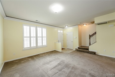 Unfurnished living room with stairway, carpet floo