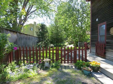 The fenced back yard is landscaped...