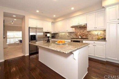 Kitchen view showing the center island, walnut har