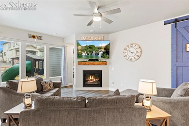 Living room with a barn door, wood finished floors
