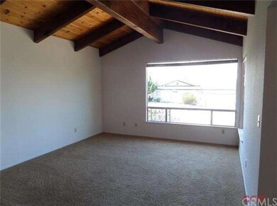 Formal living room with beautiful wood ceilings an