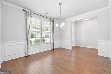 Unfurnished dining area with a notable chandelier,