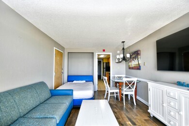 Living room featuring a textured ceiling, a chande