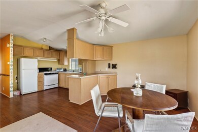 Kitchen featuring lofted ceiling, white appliances