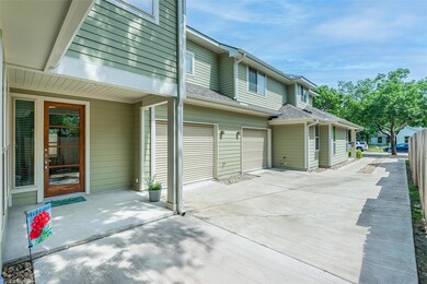 View of patio / terrace featuring driveway, a gar
