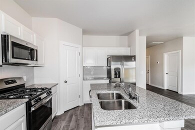 Kitchen featuring sink, tasteful backsplash, stain