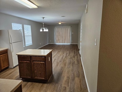 Kitchen with freestanding refrigerator, wood fini