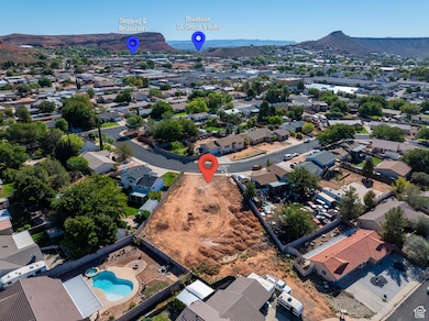 Aerial view of residential area featuring a mountain backdrop and a pool