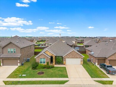 View of front facade featuring a front yard and a garage