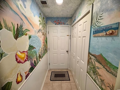 Doorway with light tile patterned floors